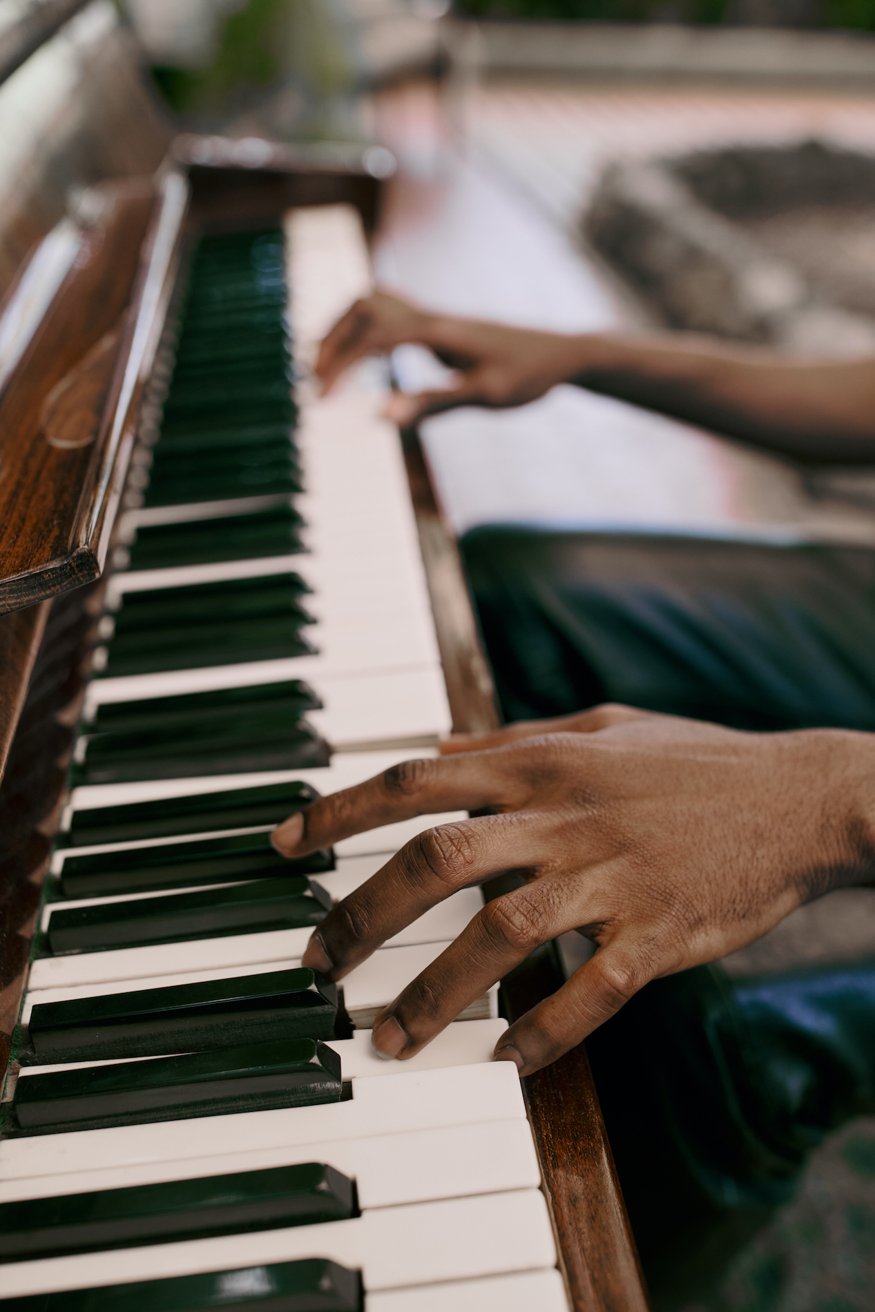 Close-up of hands playing a piano keyboard
